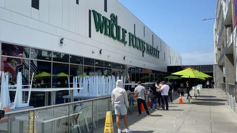 Social Distancing on front of grocery store Stock Footage 127789281