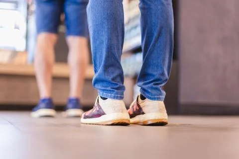 Social distancing people standing in queue in cafe. Stock Photos