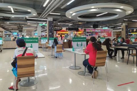 Social distancing rules in practice, alternate seating in local food courts. Stock Photos
