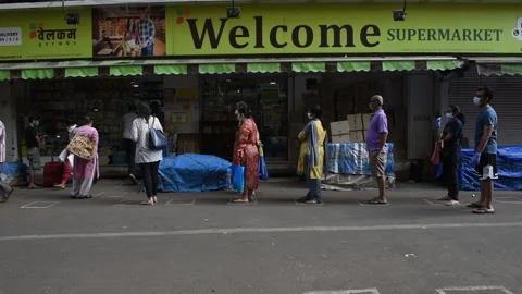 Social distancing-waiting-queue-general store-Lockdown Due To Coronavirus COVID Stock Footage 130392652