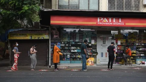 Social distancing-waiting-queue-general store-Lockdown Due To Coronavirus COVID Stock Footage 130999104