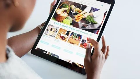 Social media, food and blog by woman influencer on digital tablet, checking Stock Photos