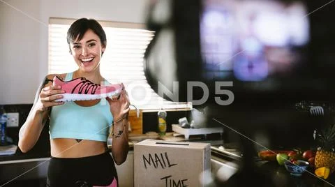 Social media influencer reviewing sports shoe Stock Photos