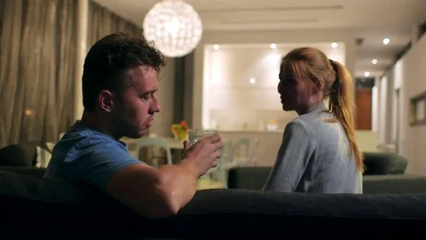 The social problem of alcoholism. Wife trying to stop husband from drinking, it Stock Footage