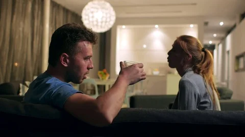 The social problem of alcoholism. Wife trying to stop husband from drinking, it Stock Footage
