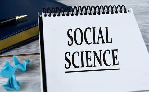 SOCIAL SCIENCE - words in a notebook on the background of a weekly and a pen. Stock Photos
