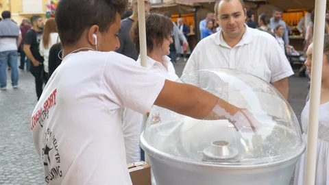 Social worker creates cotton candy Stock Footage 114453496