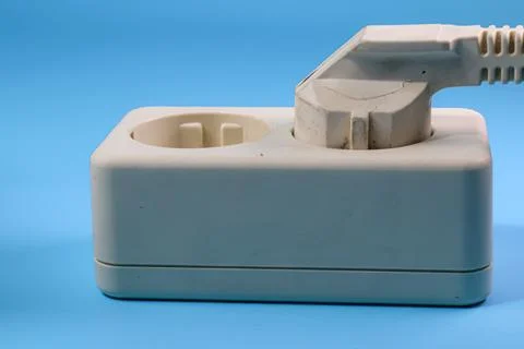 Socket and plug isolated on blue Stock Photos