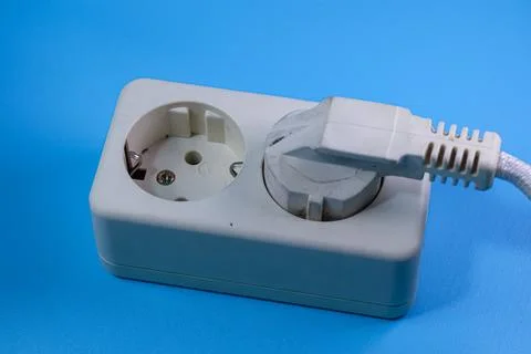 Socket and plug isolated on blue Stock Photos