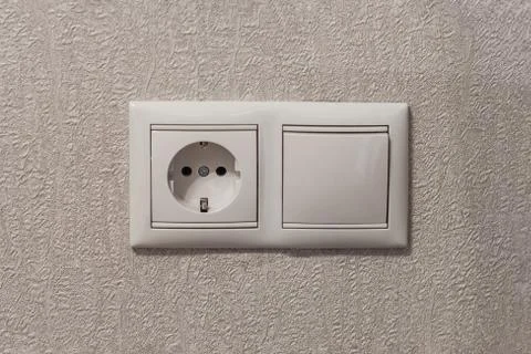 Socket and switch on beige wall close-up Stock Photos