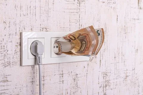 Socket and switch in the wall. the euros are in it. tariff growth. saving ele Stock Photos