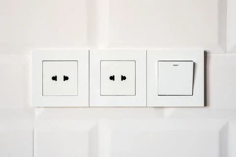 Socket and switch on the wall Stock Photos
