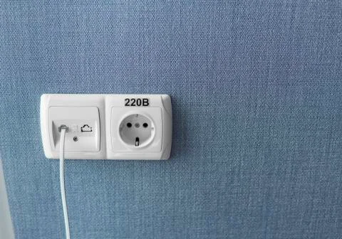 Socket on a blue wall, a multifunction outlet with an internet connection and Foto stock