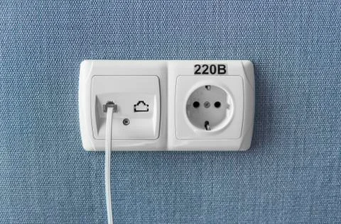 Socket on a blue wall, a multifunction outlet with an internet connection and Foto stock