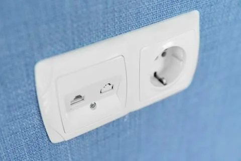 Socket on a blue wall, a multifunction outlet with an internet connection and Foto stock