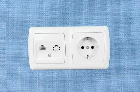 Socket on a blue wall, a multifunction outlet with an internet connection and Foto stock