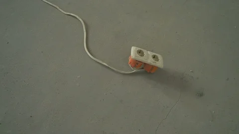 Socket with cable on the floor and electricity switches on the concrete wall. Stock Footage 110705945