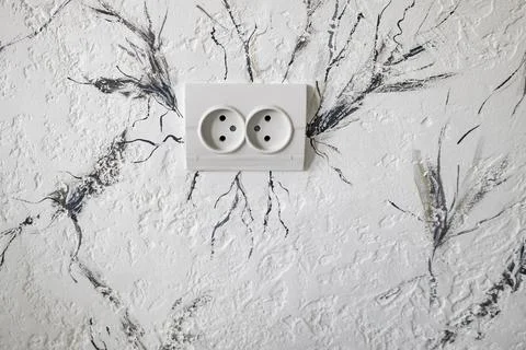 Socket for the electricity on the wall. Beautiful light  background texture.. Stock Photos