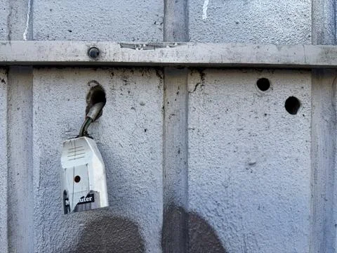 A socket for a euro plug hangs on two loose cables that were pushed through.. Stock Photos