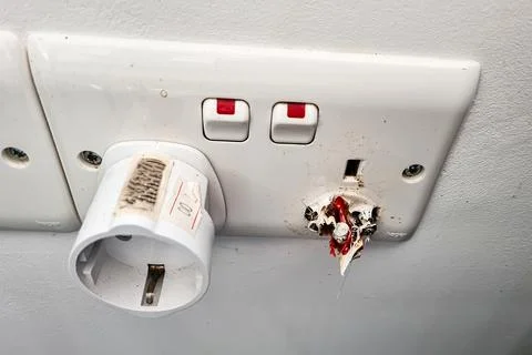 Socket fire due to short circuit. Electrical socket burnt out and damaged, .. Stock Photos