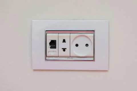 A socket on a light gray wall, a multifunction outlet with an internet connec Foto stock