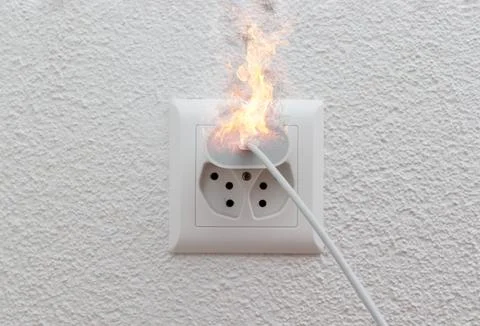 Socket or wire plug malfunction burning phone charger in indoor, electric short 库存照片