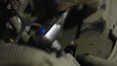 A socket ratchet wrench with blue button inside dusty engine Stock Footage 336713135