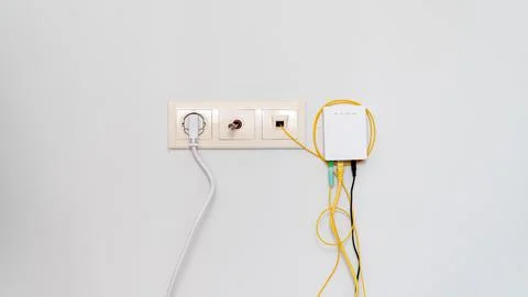 Socket with tangled wires, cables and Internet router on a white background Stock Photos