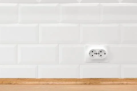 Socket in white kitchen interior with tiled wall and wooden countertop Stock Photos