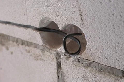 Socket with a wire in aerated concrete for an electrical outlet. House constr Photos