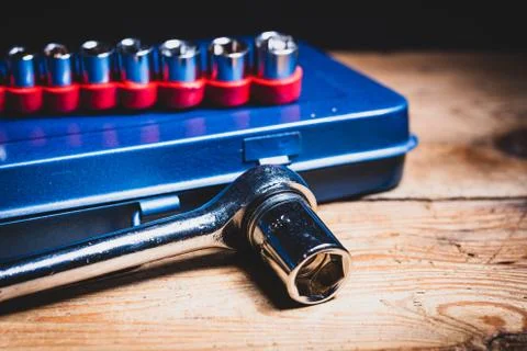 A socket wrench and its inserts on a blue tool box Stock Photos