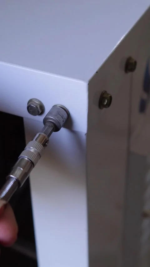 Socket wrench being used to tighten a hex bolt on a white metal structure Vídeos de archivo 332998284