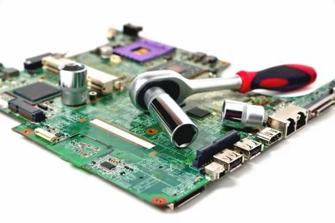 The socket wrench lies on the old chip for the laptop, isolate, large scale,  Stock Photos