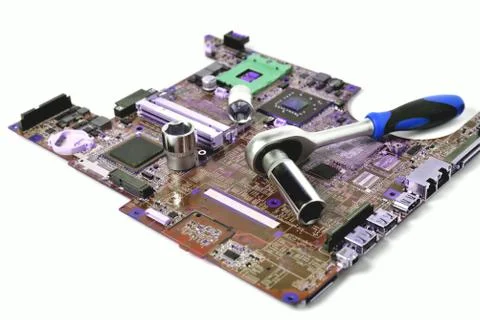 The socket wrench lies on the old chip for the laptop, isolate, large scale,  Stock Photos