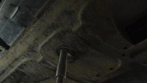 A socket wrench tightens a bolt on a car skid plate Stock Footage 340154591