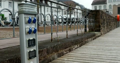 Sockets for ships and boats at a dock with an iron fence and wall Stock Footage 238944355