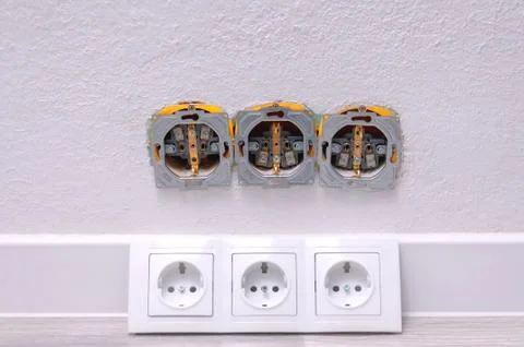Sockets in the wall close-up. Installing outlets in the room. Repair in the h Stock Photos