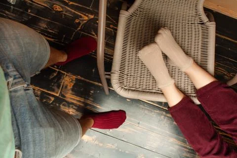 Socks close up. The guy and the girl on a wooden ladder sit. For advertising. Stock Photos