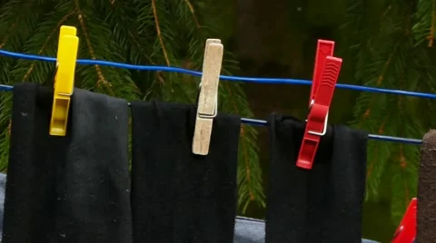 Socks on Clothesline Rope with Clothes Pegs Stock Footage 61931983