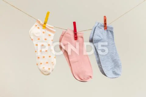 Socks hanging on roped.Blue striped socks on clothesline.Cotton or
