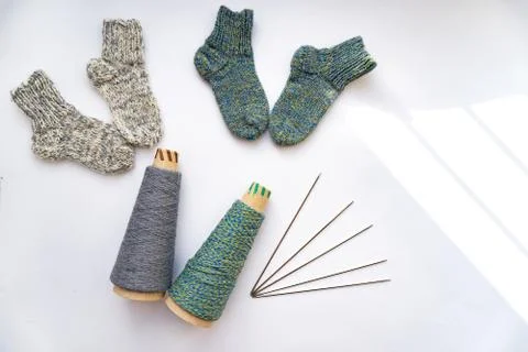Socks, thread, needles are on white background. Stock Photos