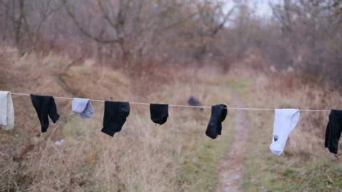 Socks in the wind hanging on rope to dry Stock Footage 165974658