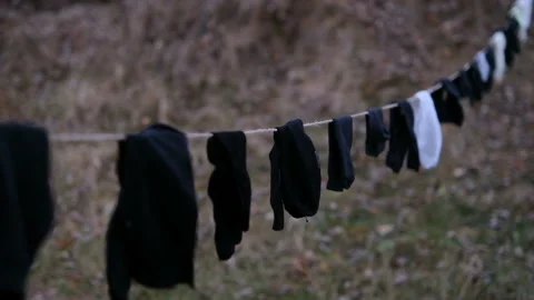 Socks in the wind hanging on rope to dry Stock Footage 167472477