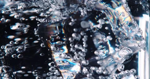 Soda and ice in the glass have bubbles. Close-up video. 動画素材 155440153