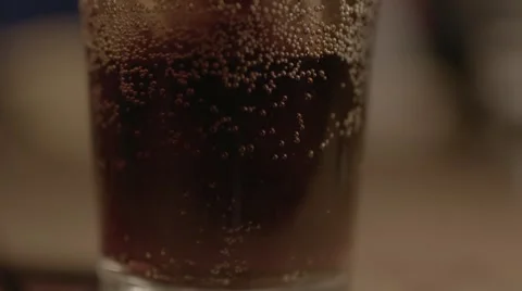 Soda bubbling, panning up, slow motion Stock Footage 56779698