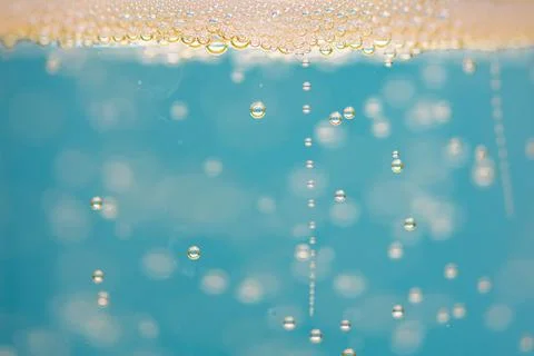 Soda carbonation bubbles in closeup macro. Soda liquid texture with transpare Stock Photos