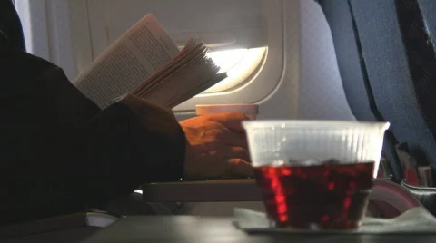 Soda in cup moves with turbulents aboard plane Stock Footage