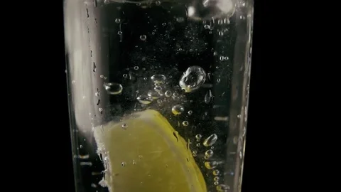 In a soda falls a slice of lemon. Slow mo Stock Footage 76154616
