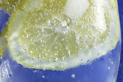 Soda with lemon on blue macro Stock Photos