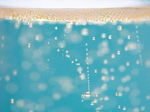 Soda macro bubbles with sparkling texture. Soda droplets in liquid with motio Фото